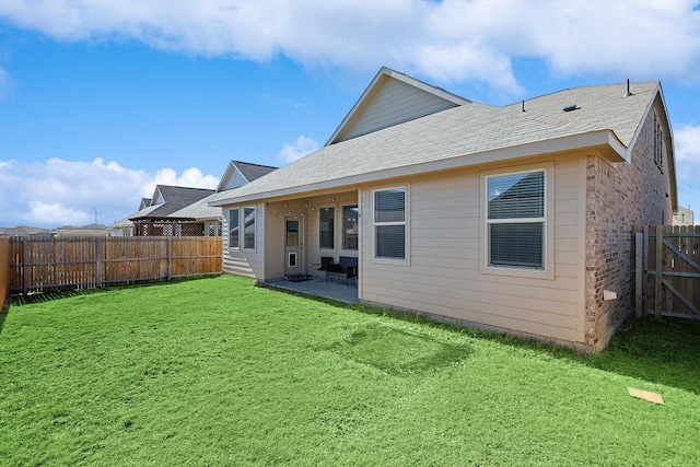 back of property with a yard and a patio