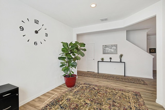 hallway with hardwood / wood-style floors