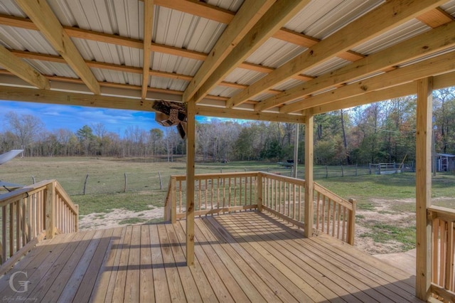 deck with a rural view and a lawn