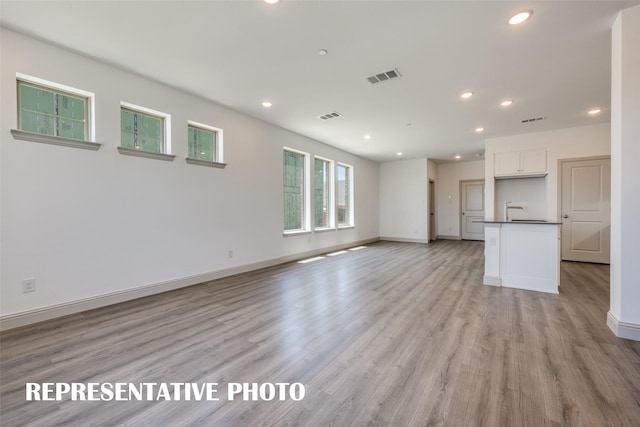 unfurnished living room with light hardwood / wood-style floors