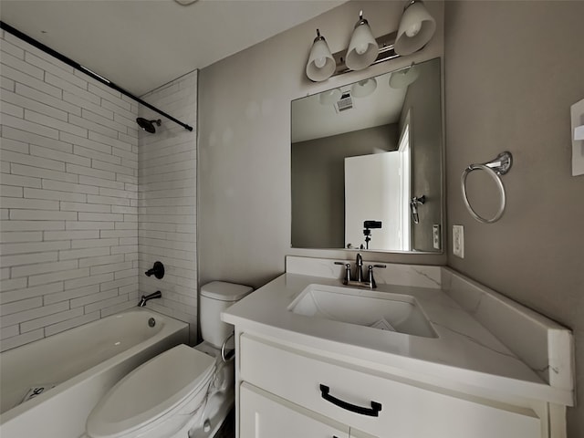 full bathroom with tiled shower / bath combo, vanity, and toilet