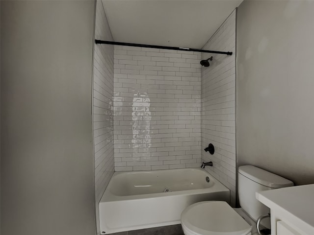 full bathroom with tiled shower / bath combo, vanity, and toilet