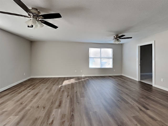 unfurnished room with hardwood / wood-style flooring, ceiling fan, and a textured ceiling