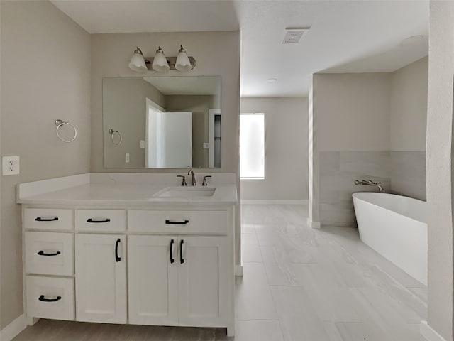 bathroom with vanity and a bathtub