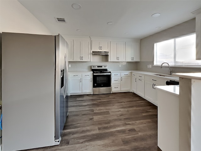 kitchen featuring appliances with stainless steel finishes, dark hardwood / wood-style floors, sink, backsplash, and white cabinets