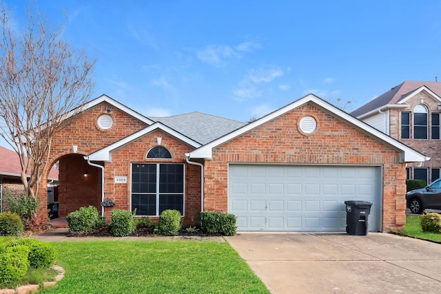 view of front property with a garage and a front yard