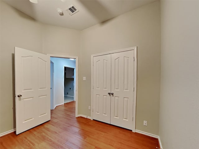 unfurnished bedroom featuring a closet and light hardwood / wood-style flooring