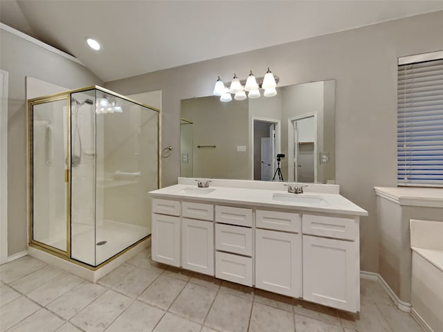 bathroom with tile patterned floors, vanity, and a shower with door