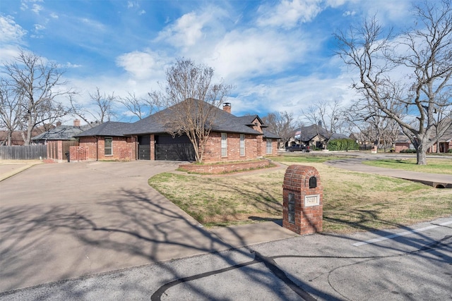 view of front of property featuring brick siding, fence, concrete driveway, a chimney, and an attached garage