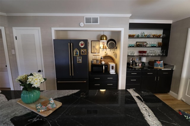 bar with high end black fridge, ornamental molding, and hardwood / wood-style floors