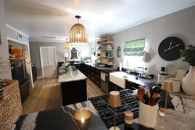 kitchen featuring pendant lighting, dishwasher, a center island, crown molding, and light wood-type flooring