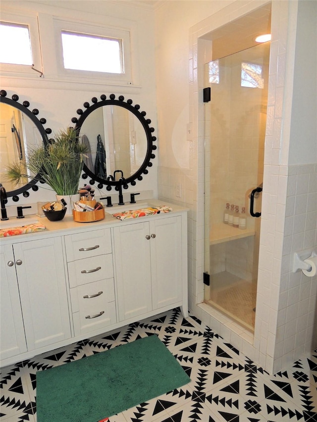 bathroom with vanity and a shower with shower door