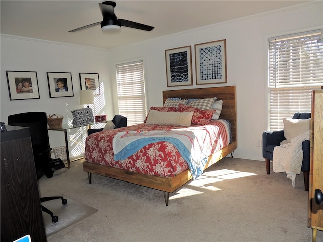 carpeted bedroom with crown molding and ceiling fan