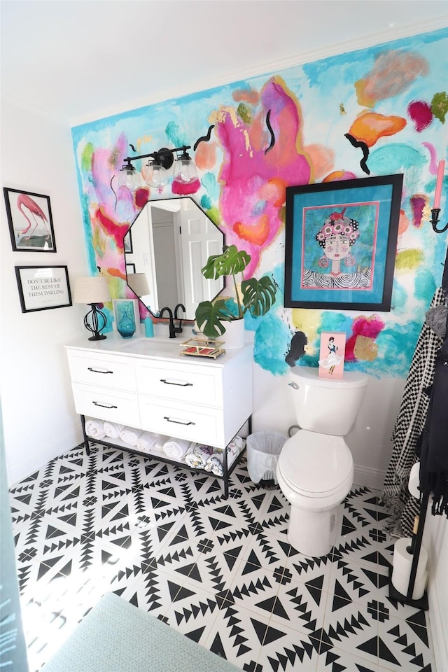 bathroom featuring tile patterned flooring, vanity, and toilet