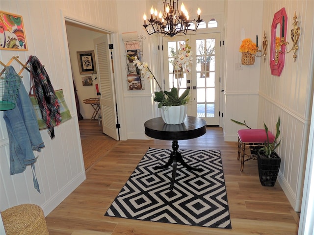 foyer with an inviting chandelier and light wood-type flooring