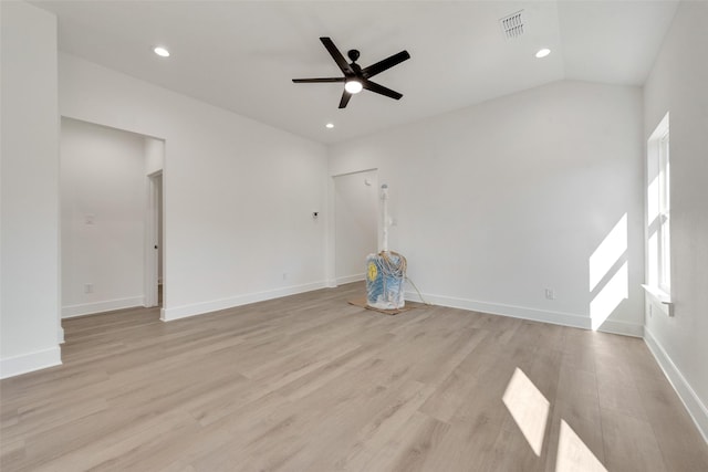 empty room featuring ceiling fan, lofted ceiling, and light wood-type flooring