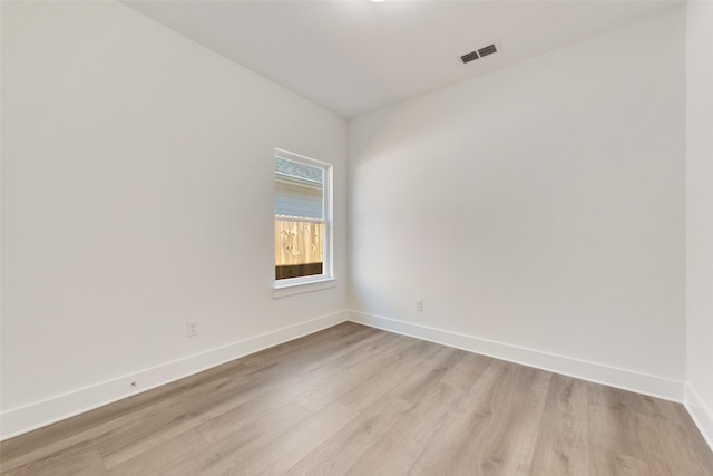 empty room with light hardwood / wood-style floors