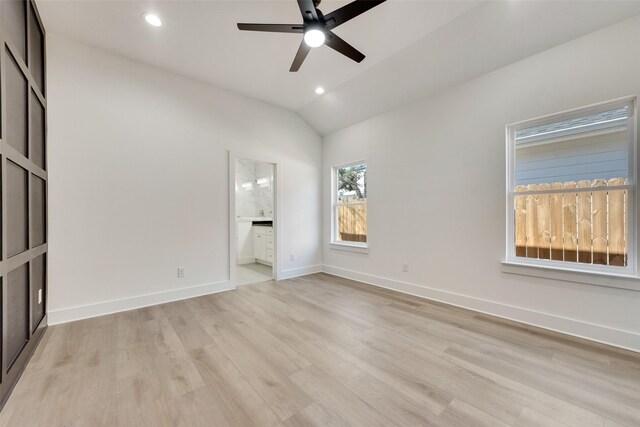 unfurnished bedroom featuring ceiling fan, lofted ceiling, ensuite bathroom, and light hardwood / wood-style flooring