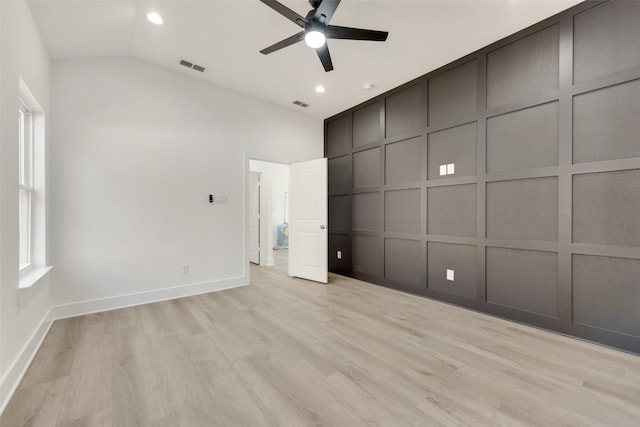 unfurnished bedroom with ceiling fan, lofted ceiling, and light hardwood / wood-style floors