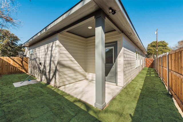 view of home's exterior featuring a lawn and a patio