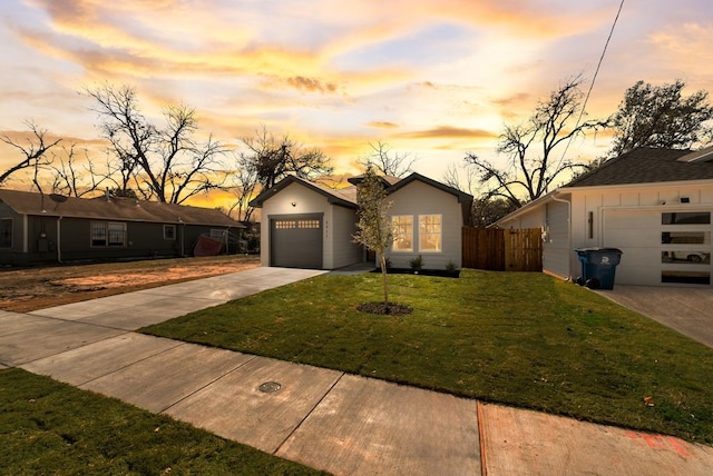 ranch-style home with a garage and a lawn