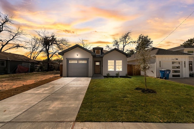 view of front facade featuring a garage and a lawn