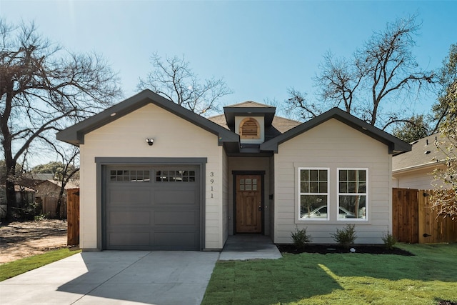 view of front of home featuring a garage and a front yard