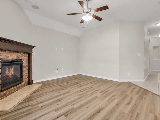 14824 Angel Trace Dr, Aledo, TX 76008 - unfurnished living room with baseboards, vaulted ceiling, a fireplace, wood finished floors, and a ceiling fan