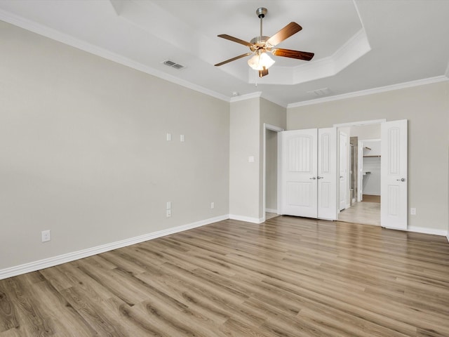 14824 Angel Trace Dr, Aledo, TX 76008 - unfurnished bedroom featuring a raised ceiling, ornamental molding, visible vents, and light wood-type flooring