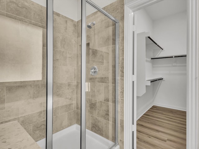 14824 Angel Trace Dr, Aledo, TX 76008 - bathroom featuring a stall shower, a walk in closet, and wood finished floors