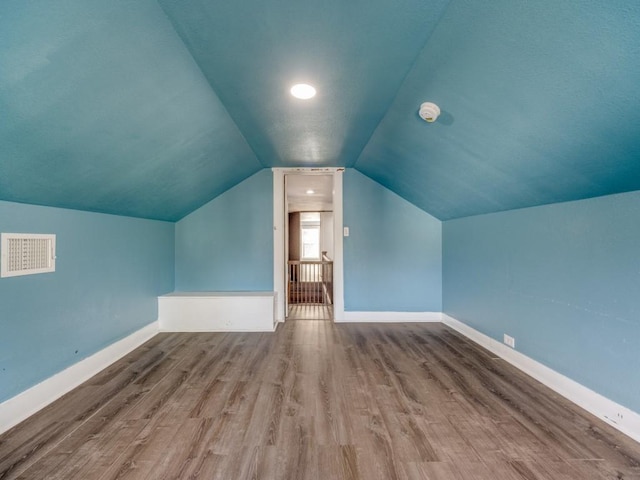 311 W Acheson St, Denison, TX 75020 - bonus room with vaulted ceiling and hardwood / wood-style floors