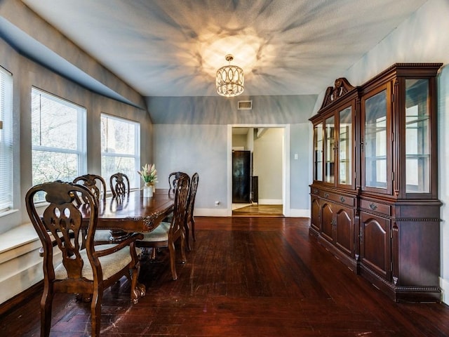 311 W Acheson St, Denison, TX 75020 - dining space with dark hardwood / wood-style floors and a chandelier