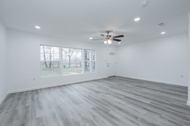 unfurnished room with ceiling fan and light hardwood / wood-style floors