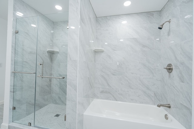 bathroom featuring independent shower and bath