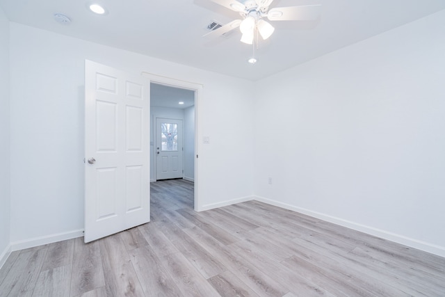 spare room featuring ceiling fan and light hardwood / wood-style floors