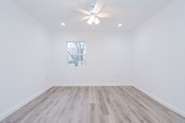 unfurnished room with ceiling fan and light wood-type flooring