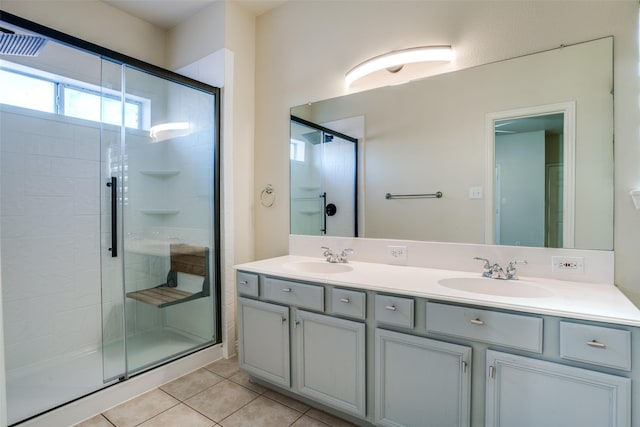 bathroom featuring tile patterned flooring, vanity, and walk in shower