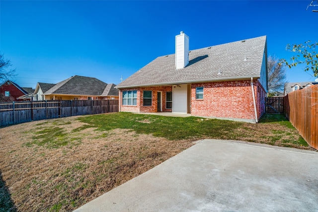 back of house with a yard and a patio area