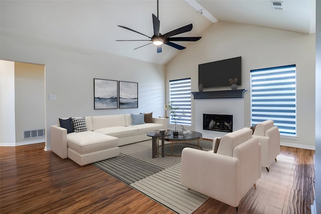 living room featuring beam ceiling, hardwood / wood-style flooring, high vaulted ceiling, and ceiling fan