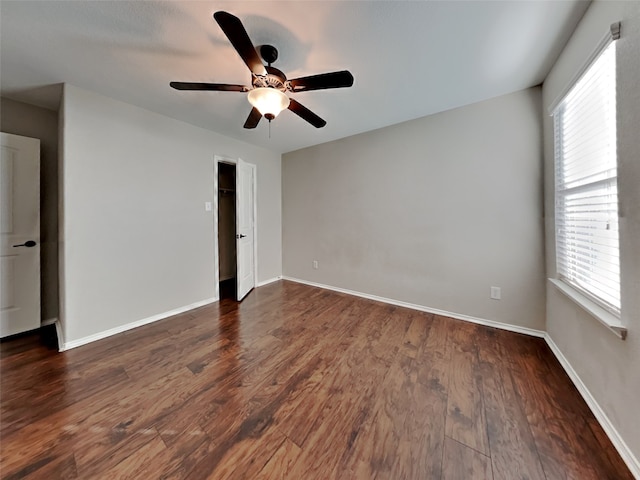 spare room featuring dark hardwood / wood-style floors and ceiling fan