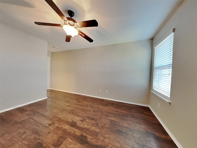 empty room featuring dark wood-type flooring and ceiling fan