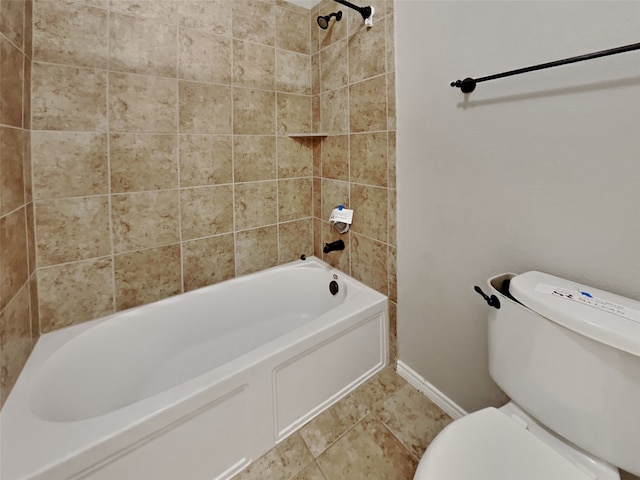 bathroom with tiled shower / bath, toilet, and tile patterned flooring