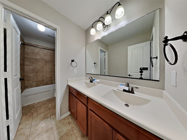 bathroom with tiled shower / bath combo, vanity, and tile patterned flooring