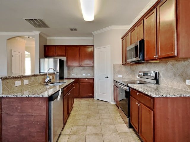 kitchen with appliances with stainless steel finishes, tasteful backsplash, sink, light tile patterned floors, and light stone countertops