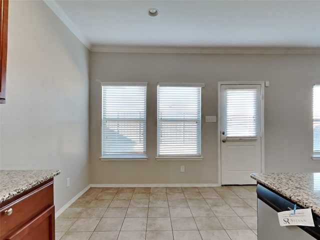 unfurnished dining area featuring light tile patterned floors and ornamental molding