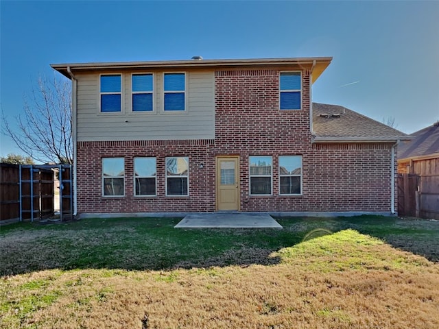 rear view of house with a patio and a yard