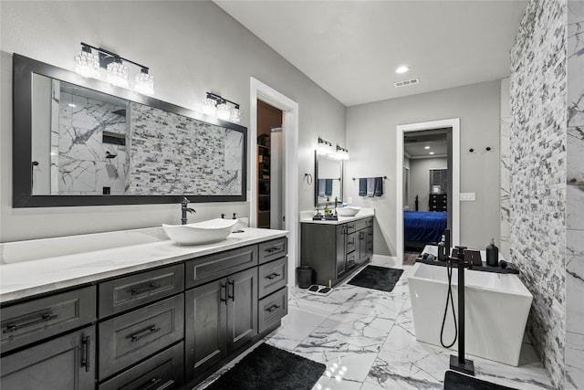 bathroom featuring vanity and a washtub