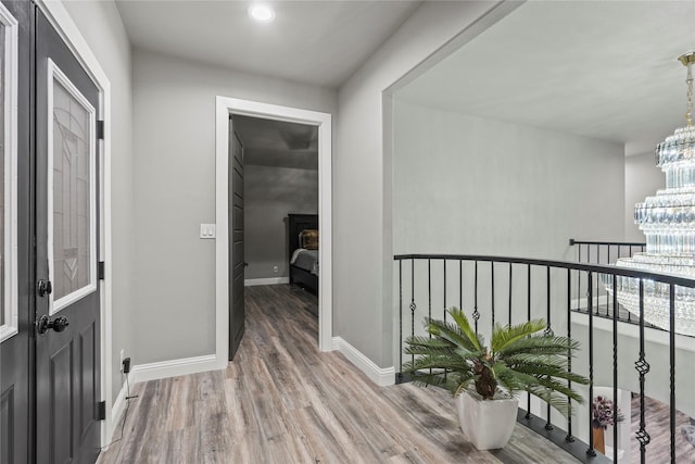 interior space featuring hardwood / wood-style floors and a notable chandelier