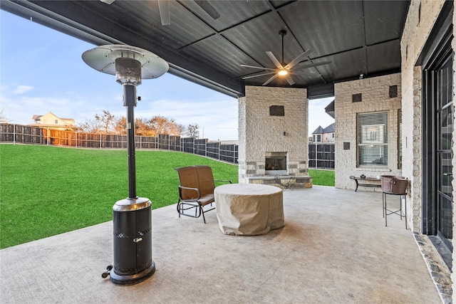 view of patio featuring ceiling fan and an outdoor stone fireplace