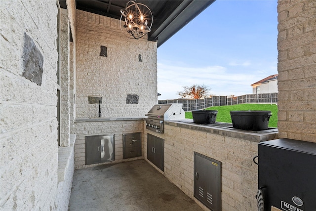 view of patio featuring area for grilling and a grill